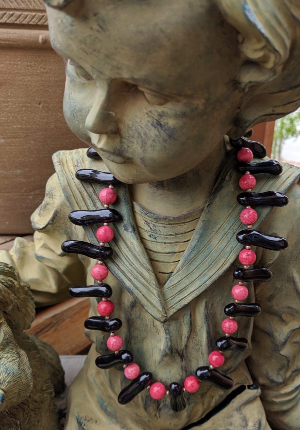 Rose and Black necklace, shown on a bit of garden statuary