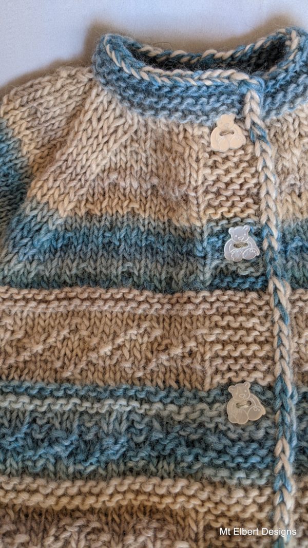 Close up of baby stripes sweater showing teddy bear buttons